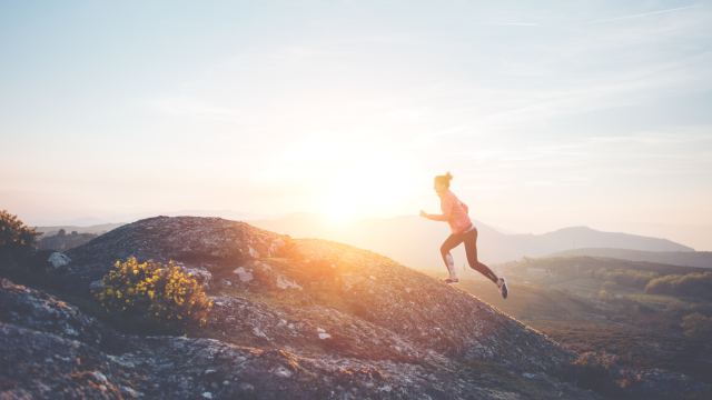 Woman Running Up Mountain